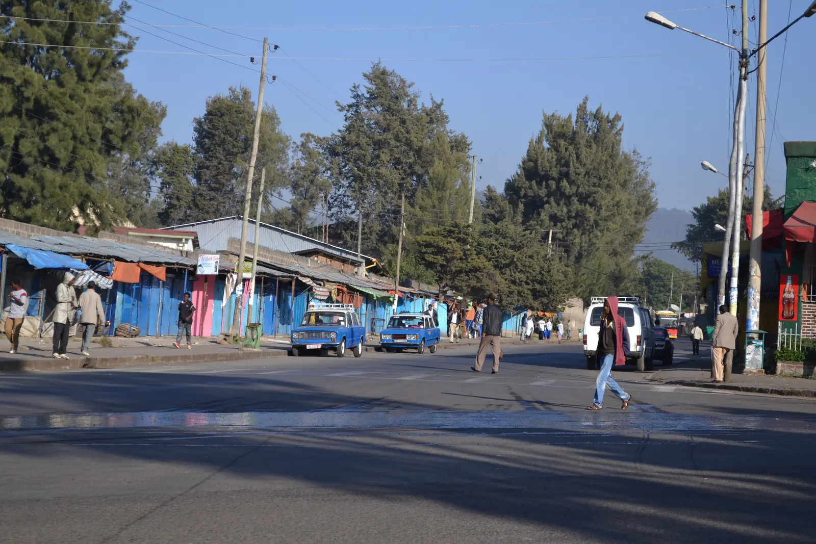 Street scene in Addis Ababa, Ethiopia, with blue-and-white taxis and pedestrians